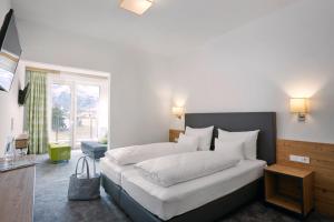 Łóżko lub łóżka w pokoju w obiekcie Hotel Zontaja Superior