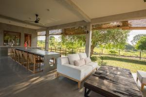 a living room with a white couch and a table at Tree Tops Yala in Yala