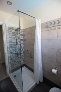 a shower with a glass door in a bathroom at Eligonia Hotel Apartments in Ayia Napa