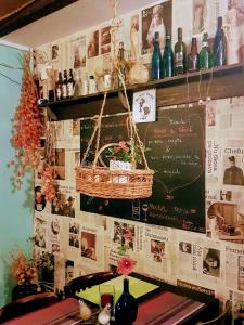 a chalkboard with a basket on the wall of a restaurant at Bistro-Pension La Teleferic in Sinaia