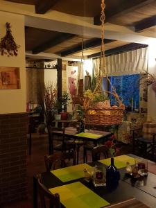 a restaurant with tables and chairs and a hanging basket at Bistro-Pension La Teleferic in Sinaia