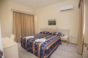 a hotel room with a bed and a desk at Eligonia Hotel Apartments in Ayia Napa