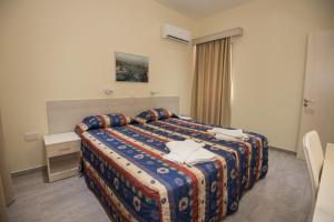 a hotel room with a bed and a window at Eligonia Hotel Apartments in Ayia Napa