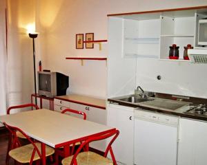 a small kitchen with a table and a sink at Residence Portofino Est in Rapallo