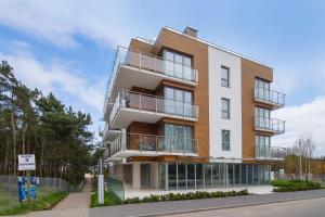 an apartment building with balconies on a street at Apartament 65 Przy plazy in Władysławowo