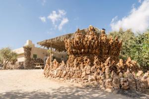 a pile of chickens sitting on the side of a building at Kfar Hanokdim - Glamping & Camping in Arad