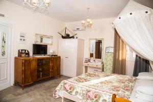 a bedroom with a bed and a dresser in it at Filoxenia Studios in Vromolithos