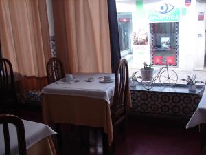 a hotel room with a table and chairs at Hotel Santa Barbara in Beja