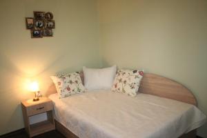 a small bedroom with a bed with a lamp on it at Yavor Apartment in Sofia