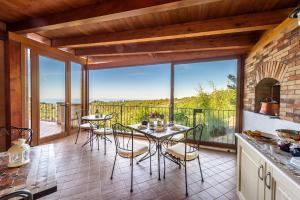 a kitchen with a table and chairs on a balcony at Villa Moreschi in Vico del Gargano +16 photos