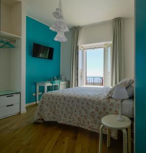 Postel nebo postele na pokoji v ubytování L'Orizzonte Relais Sirolo