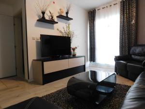a living room with a flat screen tv on a table at Sunrise Apartment in Ashkelon