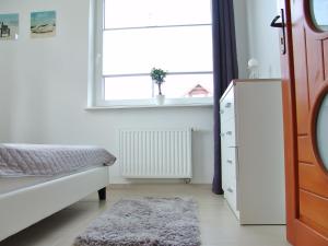 Postel nebo postele na pokoji v ubytování Apartament Białe Piaski