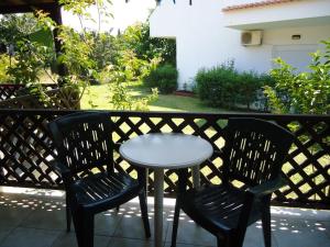 a small table and two chairs on a balcony at Hotel Zachos in Troulos
