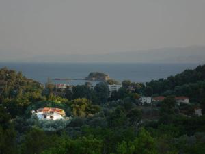 a house on top of a hill near the ocean at Hotel Zachos in Troulos