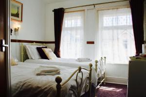 a bedroom with two beds and two windows at No 34 in Blackpool