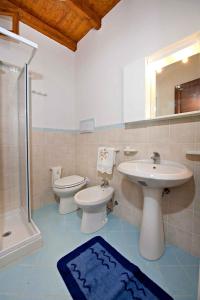a bathroom with a sink and a toilet and a shower at BILOCALE VERDI A C/MARE GOLFO in Castellammare del Golfo