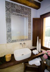 a bathroom with a sink and a mirror at Dimora Dell'Erbe Apartment in Montepulciano