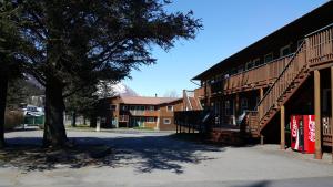 a building with a tree in front of a building at Harborview Inn in Seward