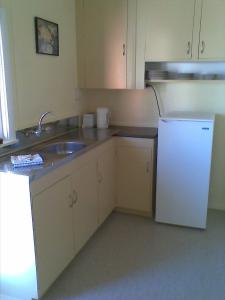 A kitchen or kitchenette at Waiteti Trout Stream Holiday Park