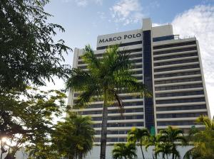a masco polo building with a palm tree in front at Marco Polo Plaza Cebu in Cebu City