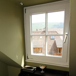 a window in a room with a wine glass at Die Dependance in Neckargemünd +26 photos