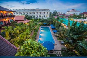 an overhead view of a resort pool with umbrellas at Kouprey Hotel in Siem Reap