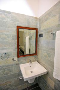 a bathroom with a sink and a mirror at My Home Guest in Polonnaruwa