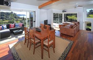 a living room with a table and chairs and a couch at Vista Twenty One in Onetangi