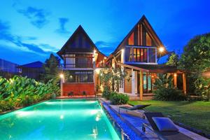 a house with a swimming pool in front of a house at iuDia Hotel in Phra Nakhon Si Ayutthaya