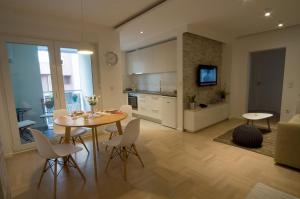 a kitchen and dining room with a table and chairs at Paula Apartment in Zagreb