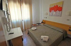 Postel nebo postele na pokoji v ubytování Hotel Aurora