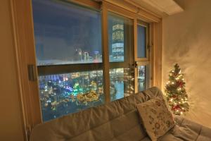 a window with a picture of a christmas tree on it at Lotte World Lake View Loft in Seoul