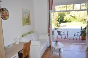 a living room with a white couch and a table at Müllers Bauernhof in Isenbüttel