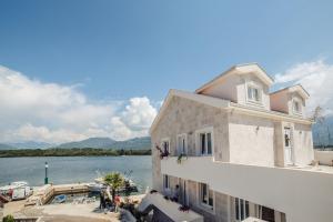 a building with a view of a body of water at Apartments Harmonia in Tivat