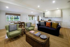 a living room with a couch and chairs and a table at Goonoo Goonoo Station in Duri