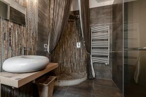 a bathroom with a shower and a sink and a tub at Milano Central Luxury in Milan