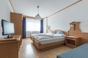 Postel nebo postele na pokoji v ubytování Pension Garden Hotel