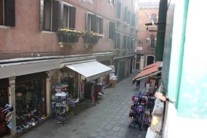 a city street with a group of shops with bikes at Salizada San Francesco in Venice