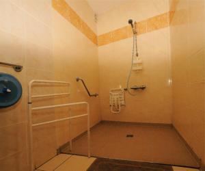 a bathroom with a shower and a toilet in it at Hotel Restaurant Maurice in Châteauroux +17 photos