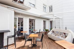 a patio with tables and chairs and a couch at Hotel Mignon Meublè in Sorrento