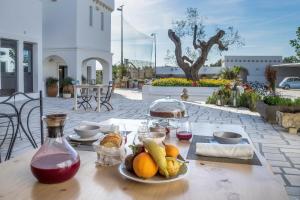 a table with a plate of fruit on it at Masseria Le Mandorle in Ugento