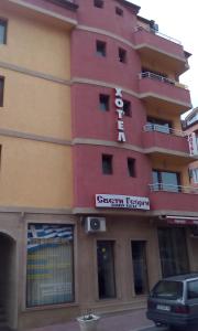 a building with a sign on the side of it at Sveti Georgi Hotel in Sandanski