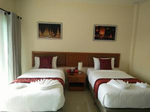 Postel nebo postele na pokoji v ubytování Lampang Green Garden Resort