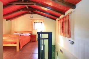 a bedroom with a bed and a red ceiling at Stone House Oreb`s Cottage in Vela Luka