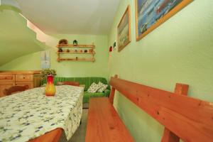 a dining room with a table with a vase on it at Stone House Oreb`s Cottage in Vela Luka