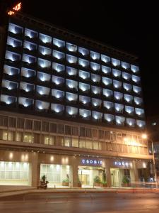 a large building with many windows at night at Capsis Hotel Thessaloniki in Thessaloniki