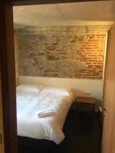 a bed in a room with a brick wall at Residence Kalliste in Ajaccio