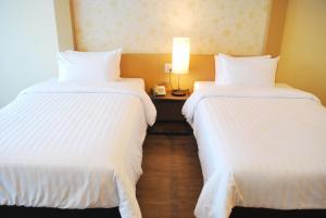 Postel nebo postele na pokoji v ubytování Rimkhobfa Urban Resort