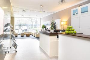 a lobby with a counter with apples on it at Hotel Astor Kiel by Campanile in Kiel